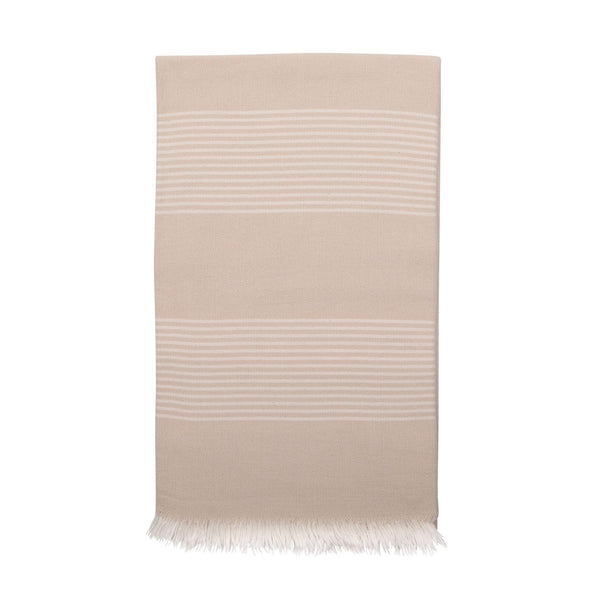 Beige hammam towel with fine white striped pattern at intervals and eyelash fringing at each end.