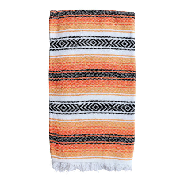 Playa hammam towel in orange, white and black stripes, folded, from Sand and Salt