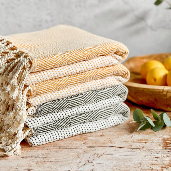 Pile of four folded Capri hammam towels.