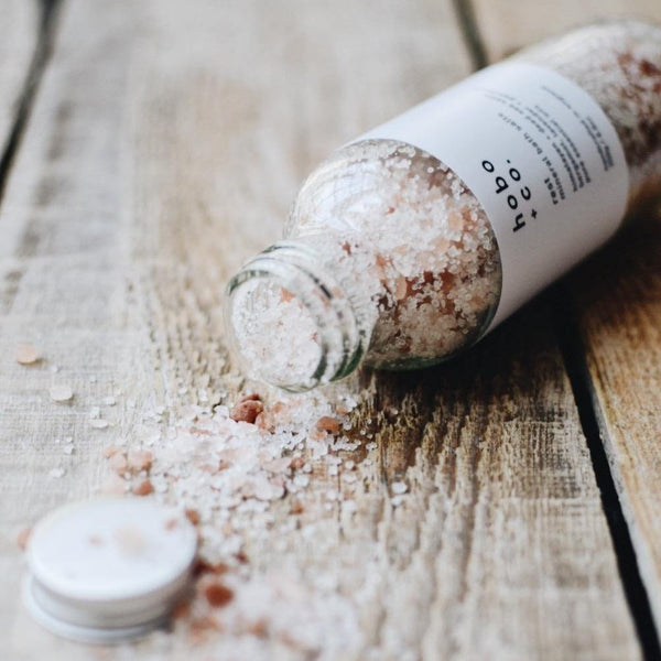 Bottle of hobo bath salts on a wooden surface