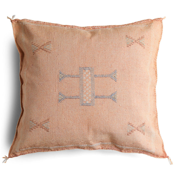A square-shaped peach-colored cactus silk cushion cover with geometric patterns and a textured finish.