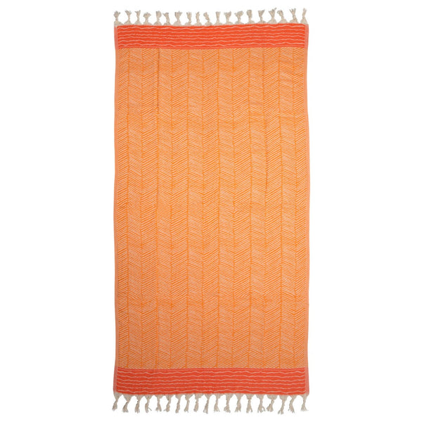 image of Skiathos hammam towel with a vibrant orange design on an off-white background. Fringing at both ends. Sold by Sand and Salt.